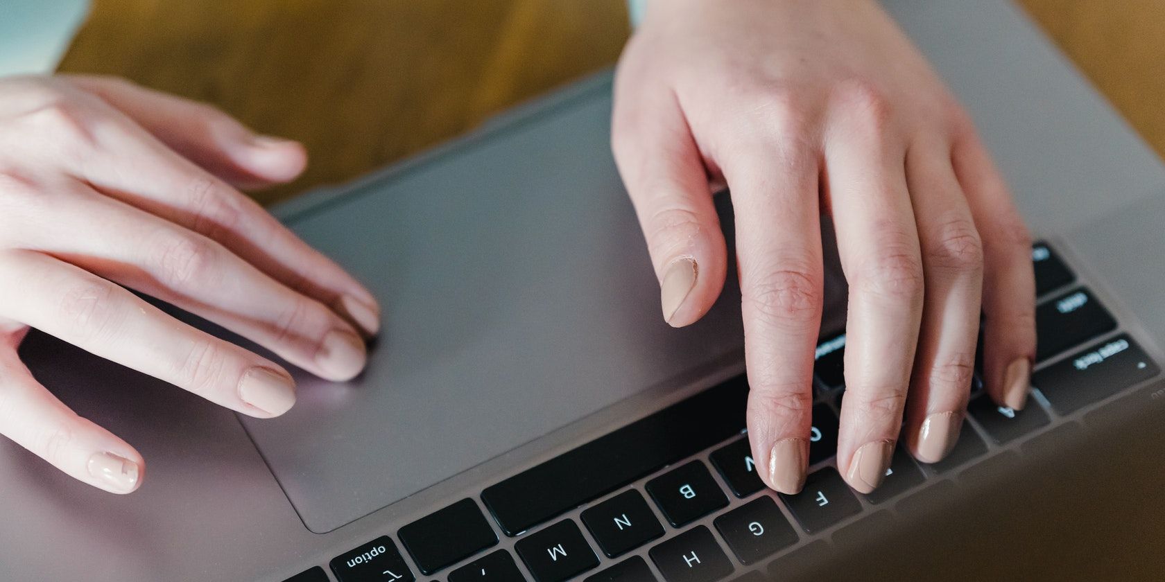 Man Using Touchpad on Laptop