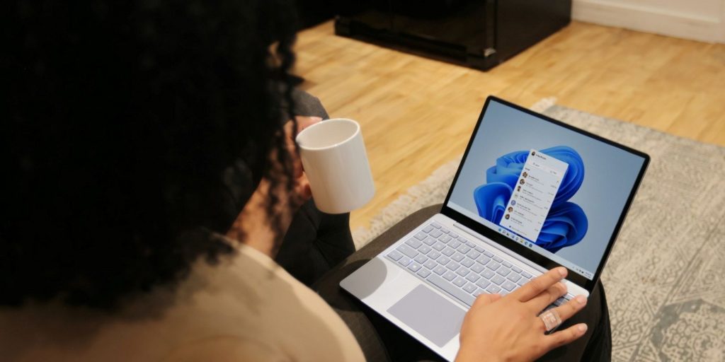 Person using a windows pc and holding a cup.jpg