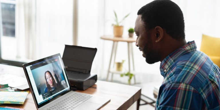 man talking to woman on zoom using laptop