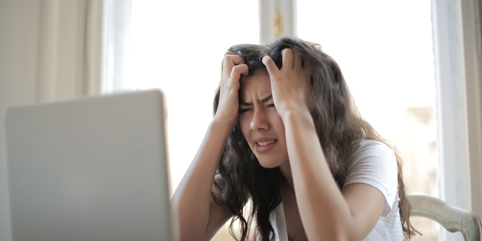 woman frustrated infront of laptop