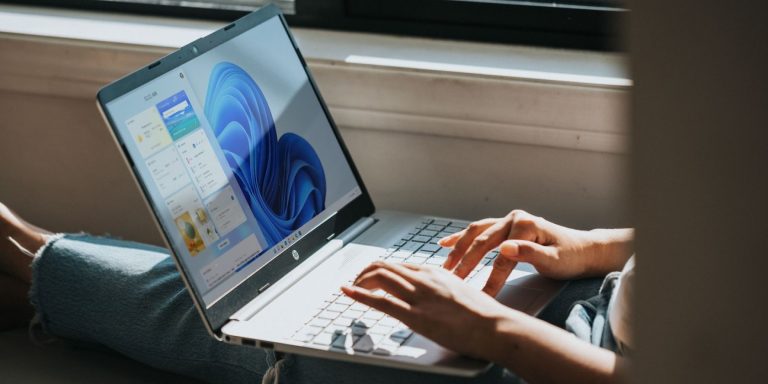 person typing on windows laptop