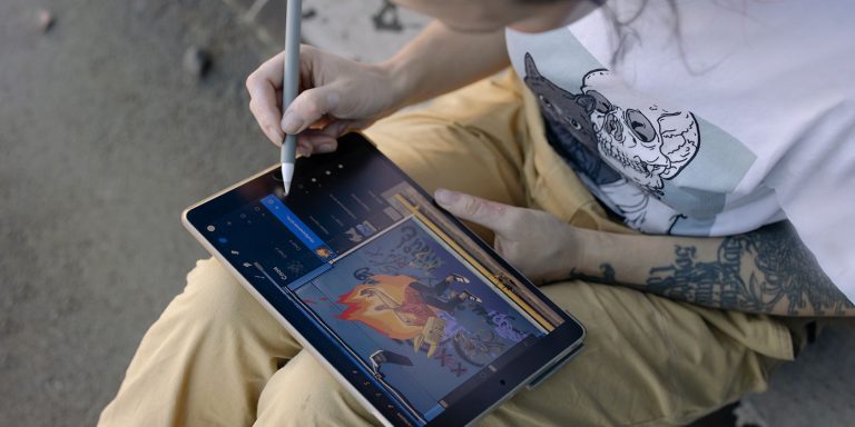 cover artist working on art with a tablet