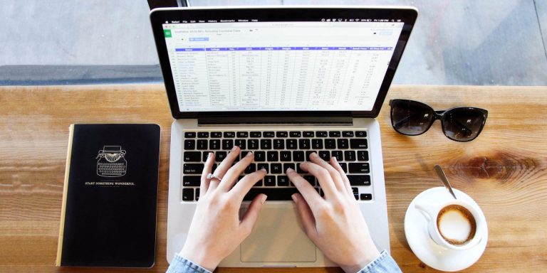 person analyzing data on a laptop