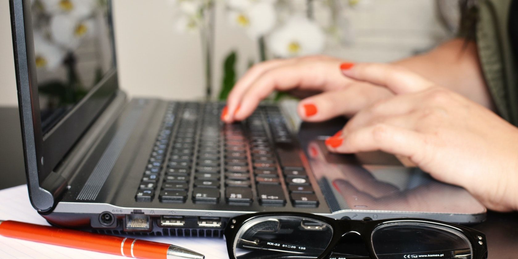 a pair of hands working on a pc