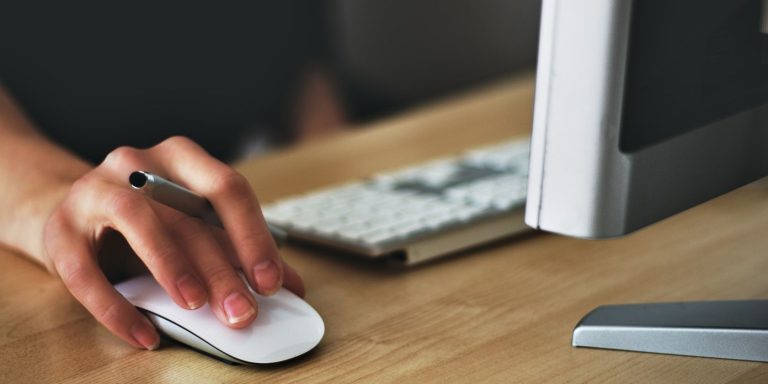 person holding mouse image 1