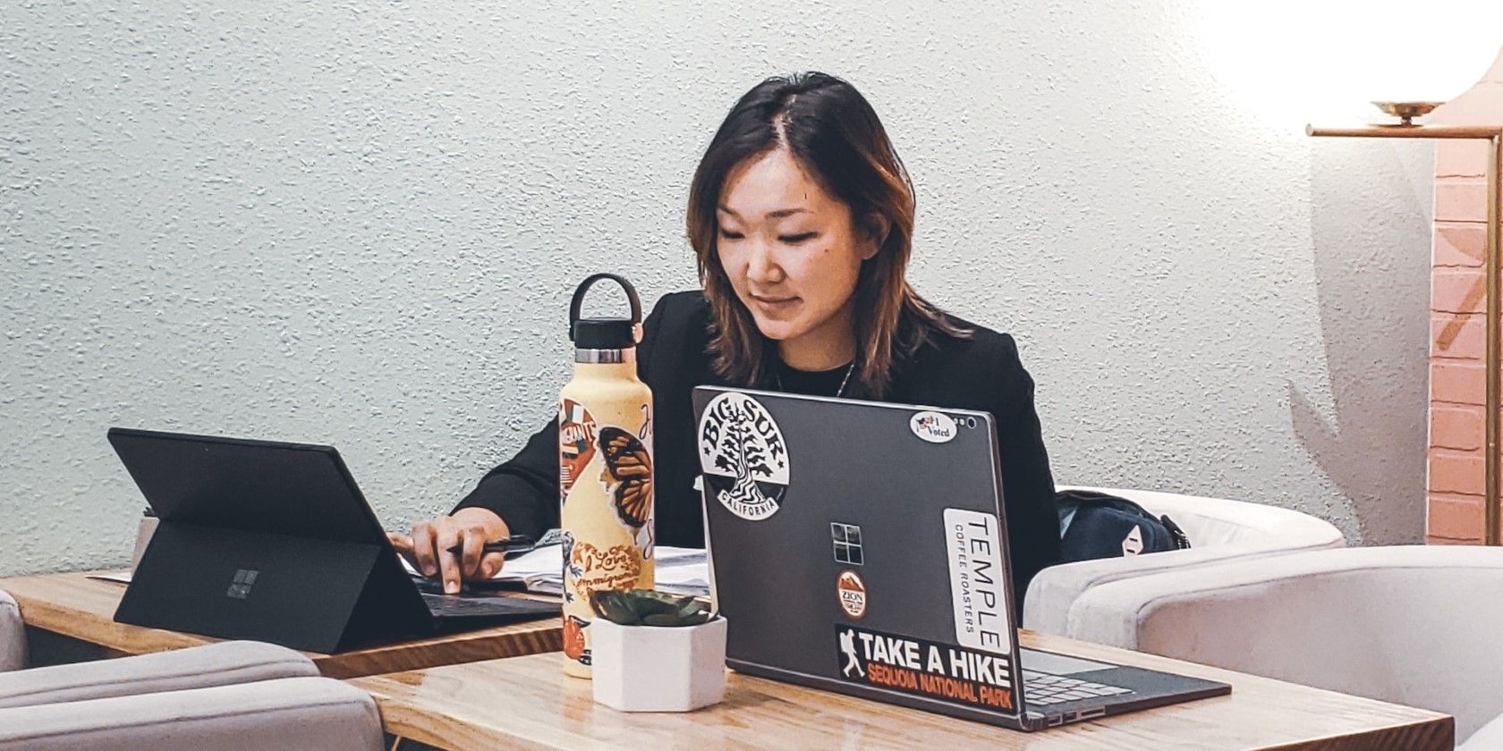 a woman using a black laptop