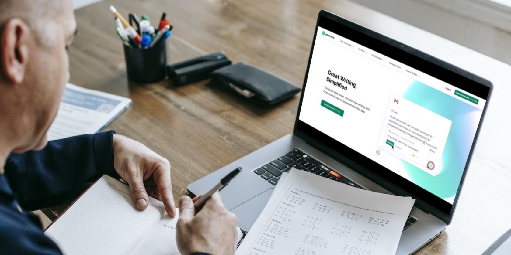 man working with laptop displaying grammarly homepage 1