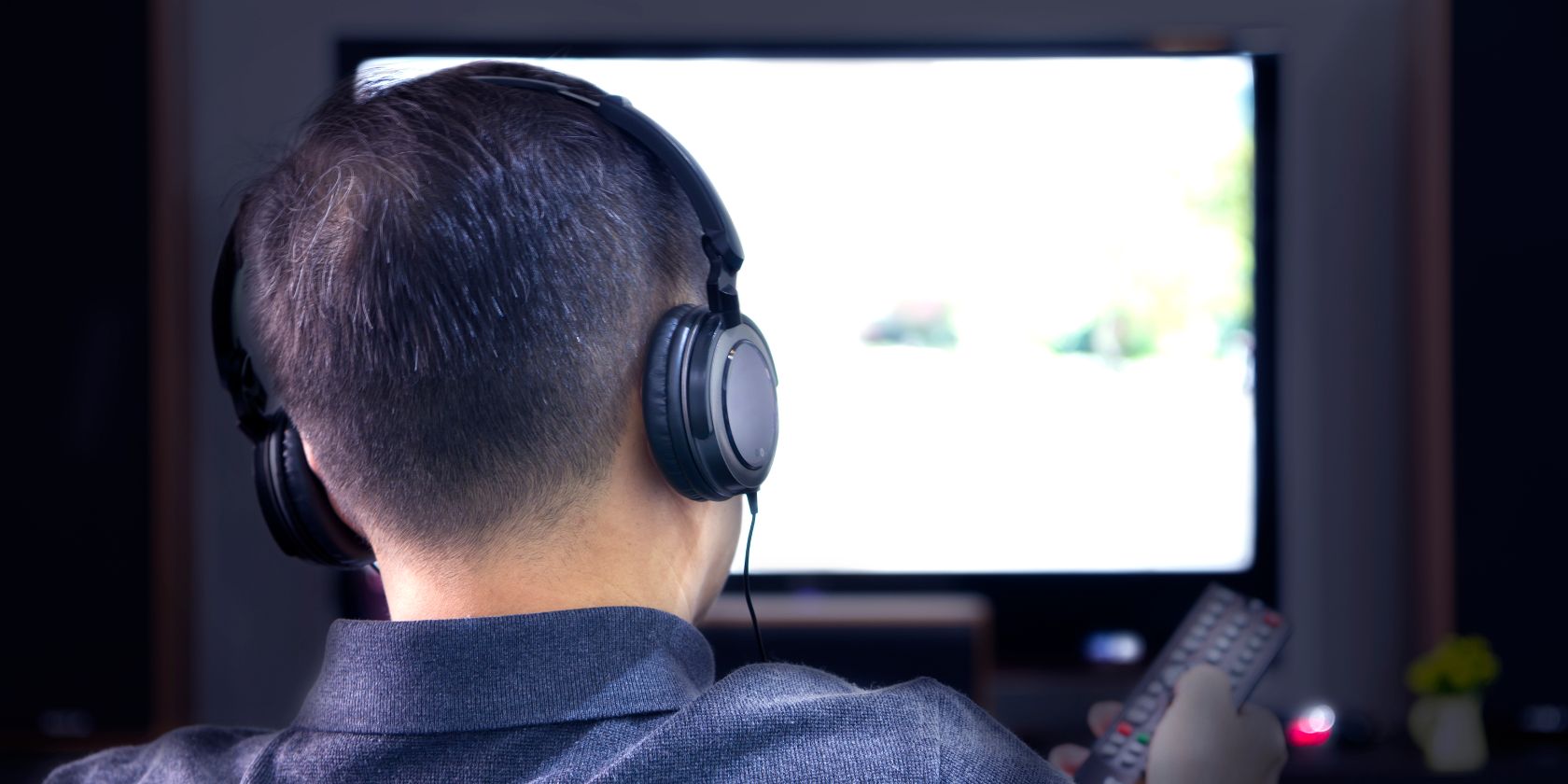 person wearing headphones watching tv