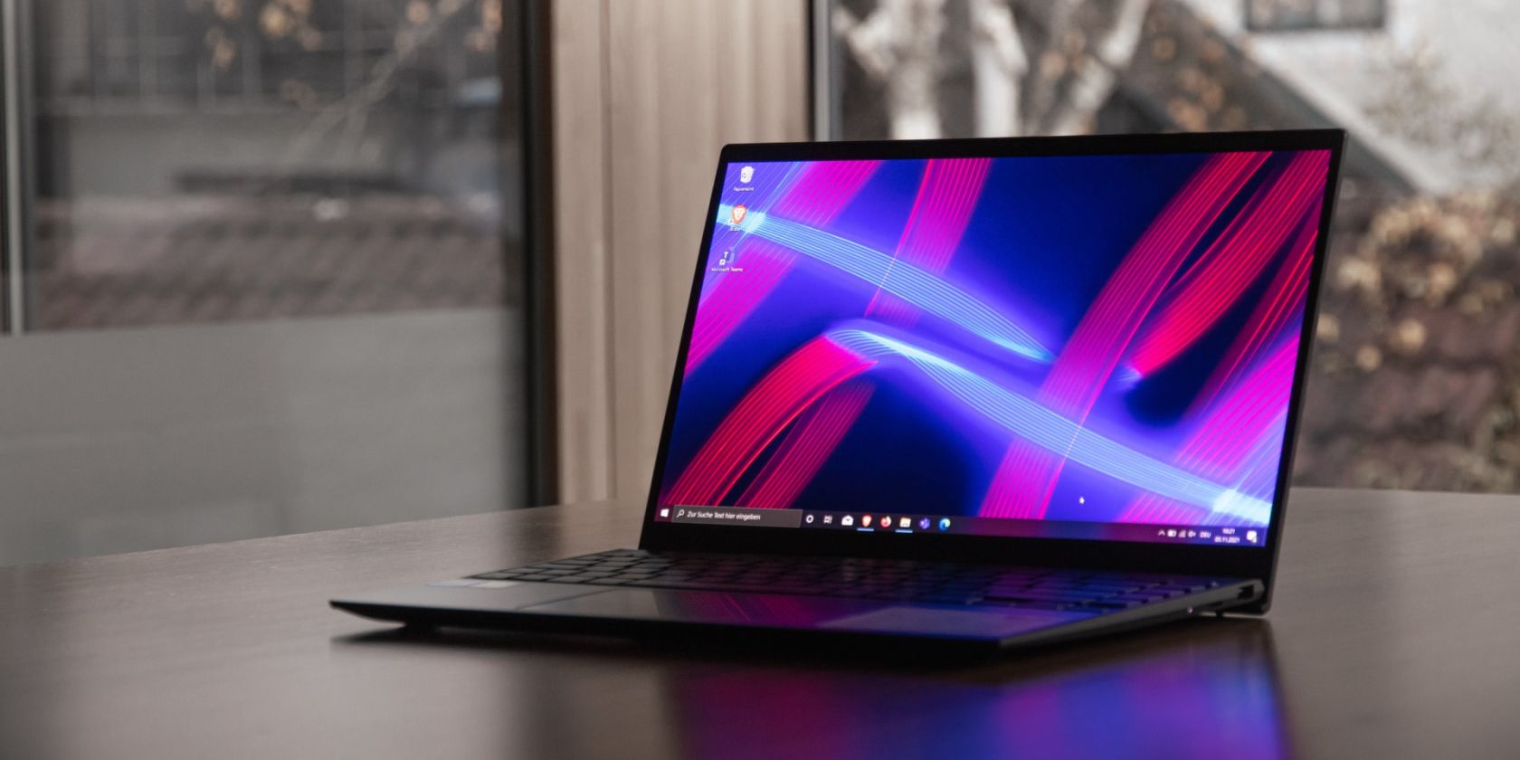 windows 10 laptop is placed on the table