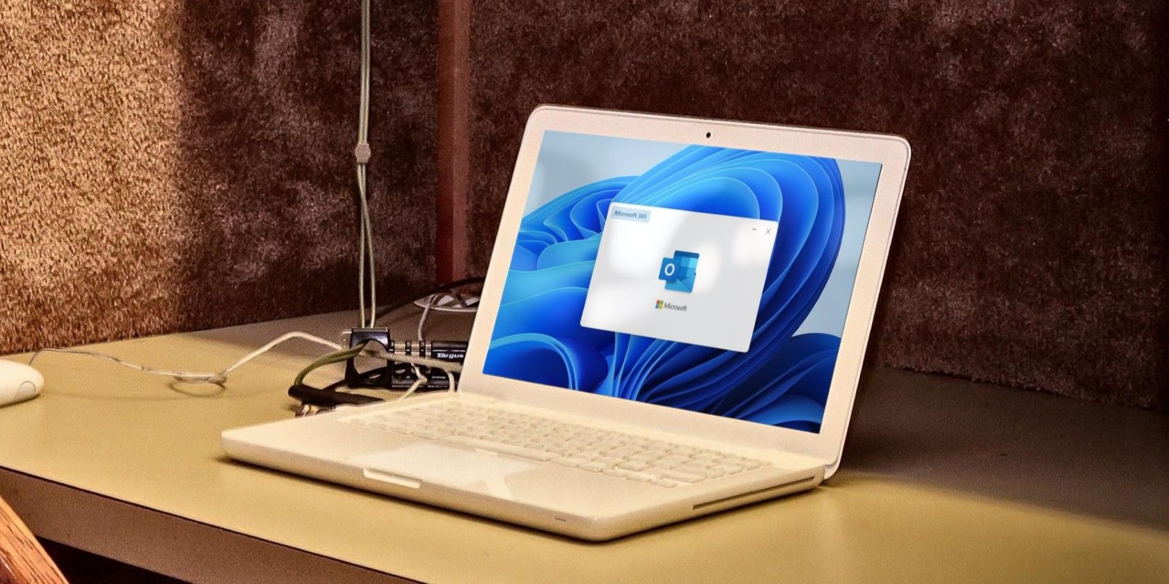 a white laptop on a wooden table