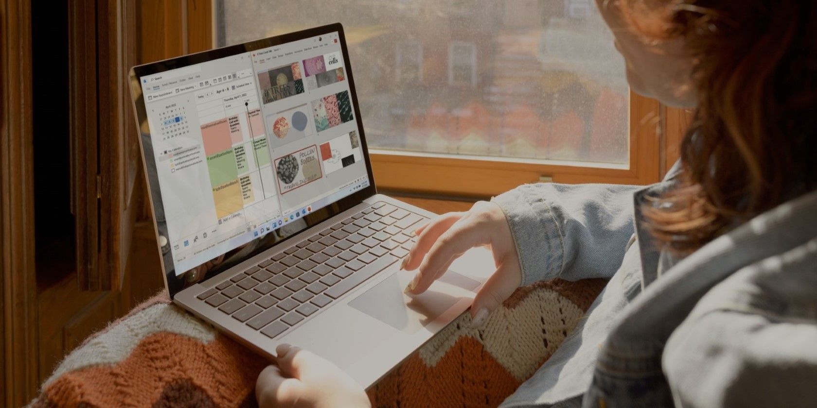 a woman using a gray windows laptop