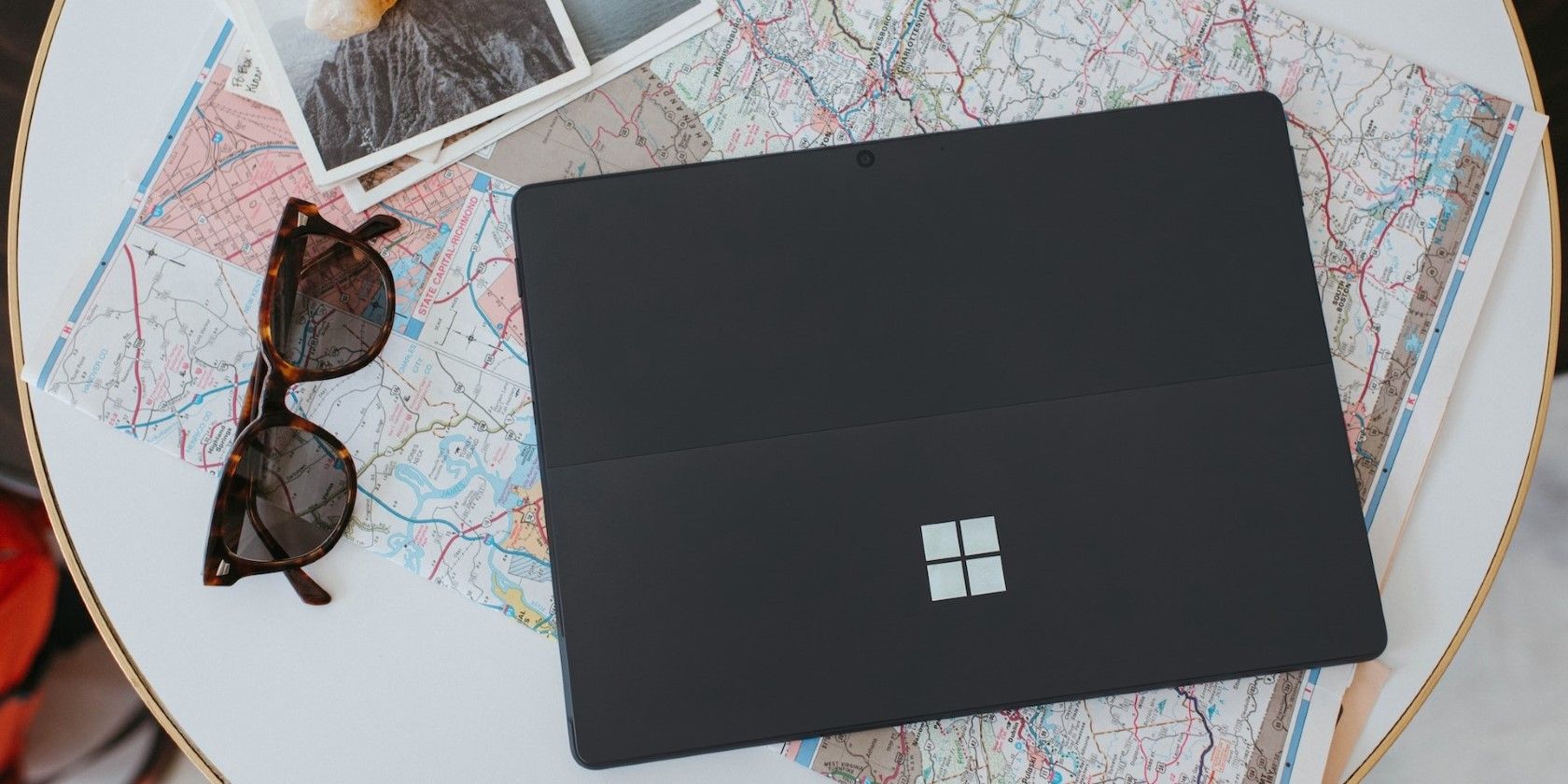 a black windows laptop on a white table
