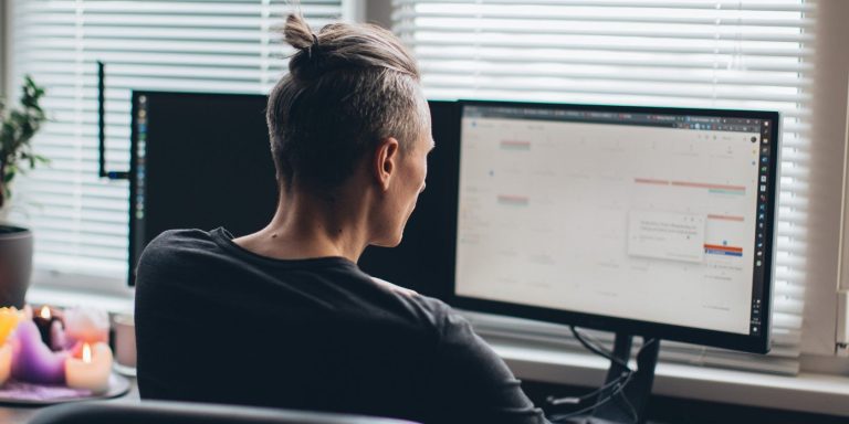 a man in front of his computer