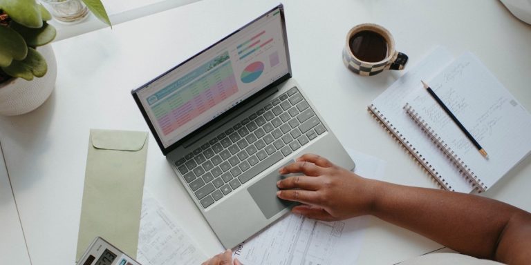 a person sitting at the table with a laptop