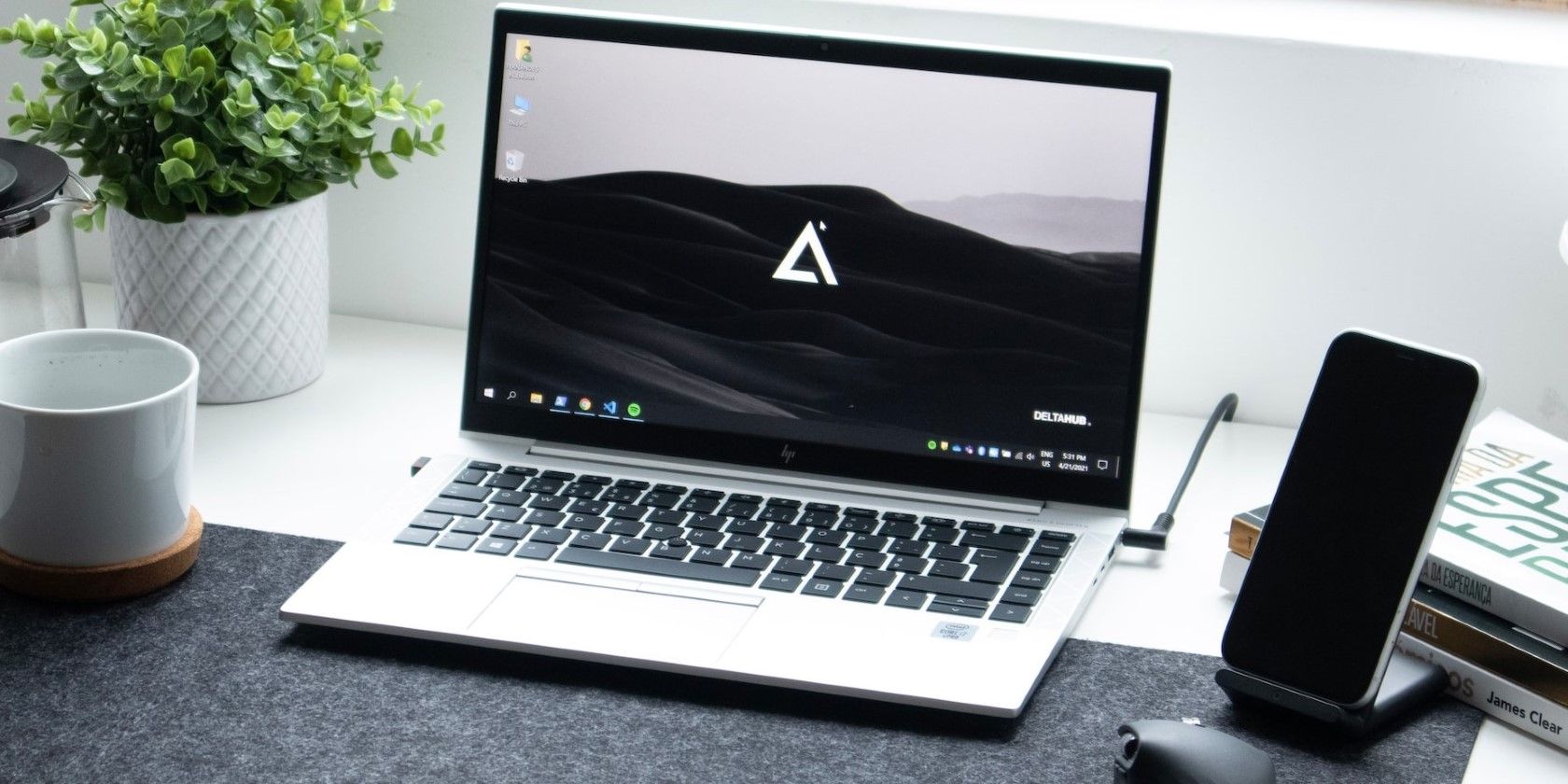 a silver laptop on a white table