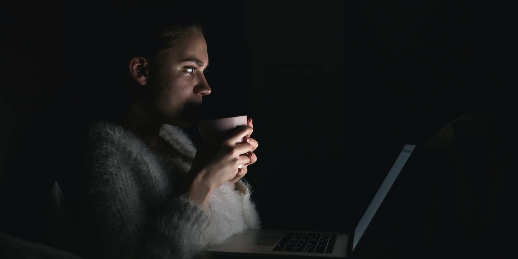 woman watching something in the dark