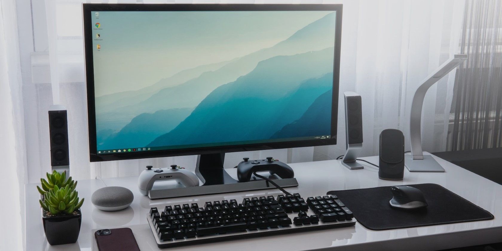 a black computer on a plain white desk