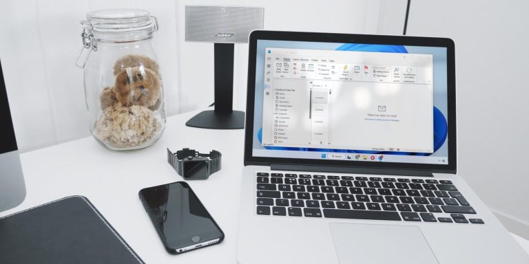 a silver laptop running outlook on a table